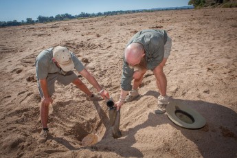Nep and Bruce draw water from a hole in the Limpopo River. The water is harmless and can be drunk immediately.