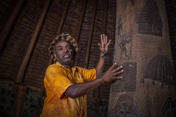 
Cultural guide Georgy Passil explains the significance of the totem carvings in a Kanak community hut on the grounds of the Tjibaou Cultural Centre.