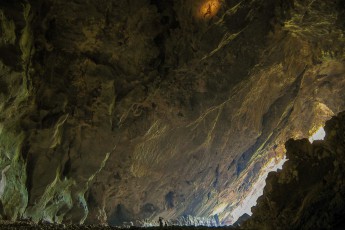 Laos. The gigantic caves of Laos inspire us. In this cave we are all alone.
