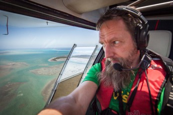 The author in a two-seater airplane during a sightseeing flight over the coral reef.