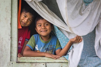 In the village Jamaikari of the indigenous Cabécar, Maximiliano and Ketelik look out of the window of their home.
