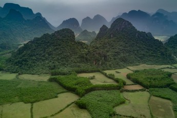 Near Phong Nha, Vietnam. Outside the national park the few areas between the rugged dense karst rocks are used for the cultivation of rice and vegetables.