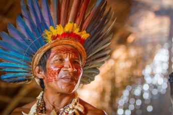 Pinon, Häuptling der Tucano, in seinem Dorf am Amazonas, Brasilien. Stolz präsentiert er seinen Kopfschmuck, dekoriert mit Papageien-Federn.