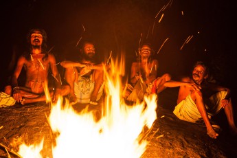 The men exchange their adventures of the day and their remembrances at the vespertine campfire.