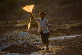 Burma/Myanmar: A boy playing with his kite made of rags (near Monywa).