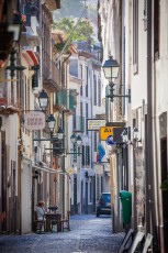 Funchal, early in the morning, a sidewalk cafe is open.