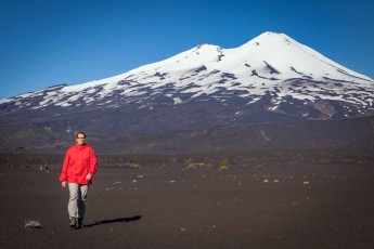 Annette in front of the 3125 metre high Llaima volcano, one of the most active in Chile. During the 2008 eruption, 54 tourists were trapped by the lava before a rescue team evacuated them.