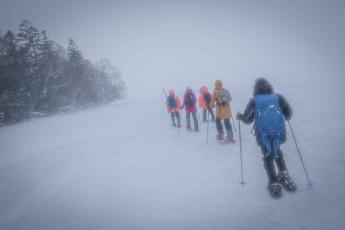 Strong winds make visibility difficult during our snowshoe hike on frozen Lake Akan.