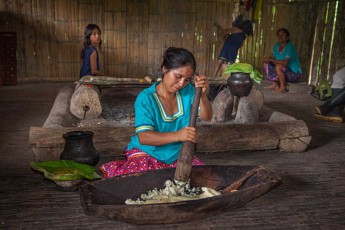 Cinthia mashes a mixture of manioc and grated sweet potato, which is then fermented for 3-4 days.
