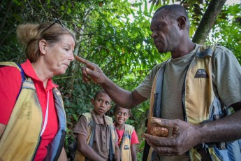 Santu Island: Our guide Tony performs a simple face-painting ceremony in front of the entrance to the Millennium Cave. This expresses respect for the spirits of the cave and asks for their protection.