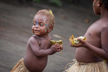 In the village of Imaio on the island of Tanna: This child has just got hold of a freshly prepared portion of laplap.