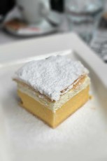 The legendary Bled cream cake (kremšnita) - baked since 1953, combines paper-thin puff pastry with silky vanilla custard and has become the sweet symbol of the spa town Bled.