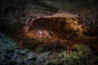 In the cathedral-like entrance hall of Pivka Cave, my three companions look like gatekeepers to one of the most spectacular cave systems in Europe.