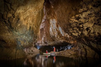The Pivka Cave opens up before me like an underground ballroom. The mirror-smooth water doubles all the stalactite formations, and my guides appear to me like ferrymen in a realm of stone and time.